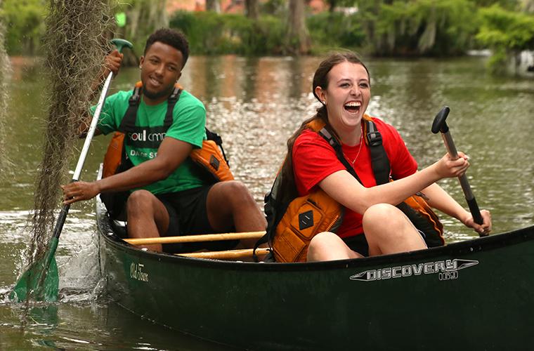 Students participate in canoe races in UL 69传媒's Cypress Lake